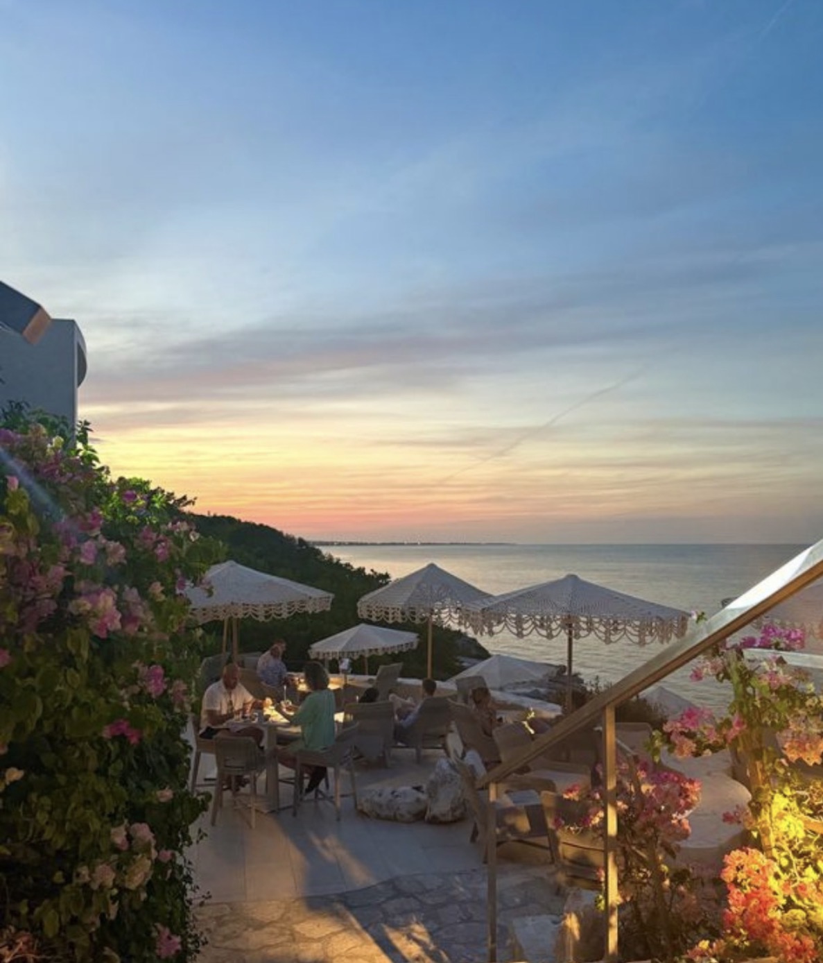 Cliffside restaurant terrace at sunset overlooking the ocean in Turks and Caicos